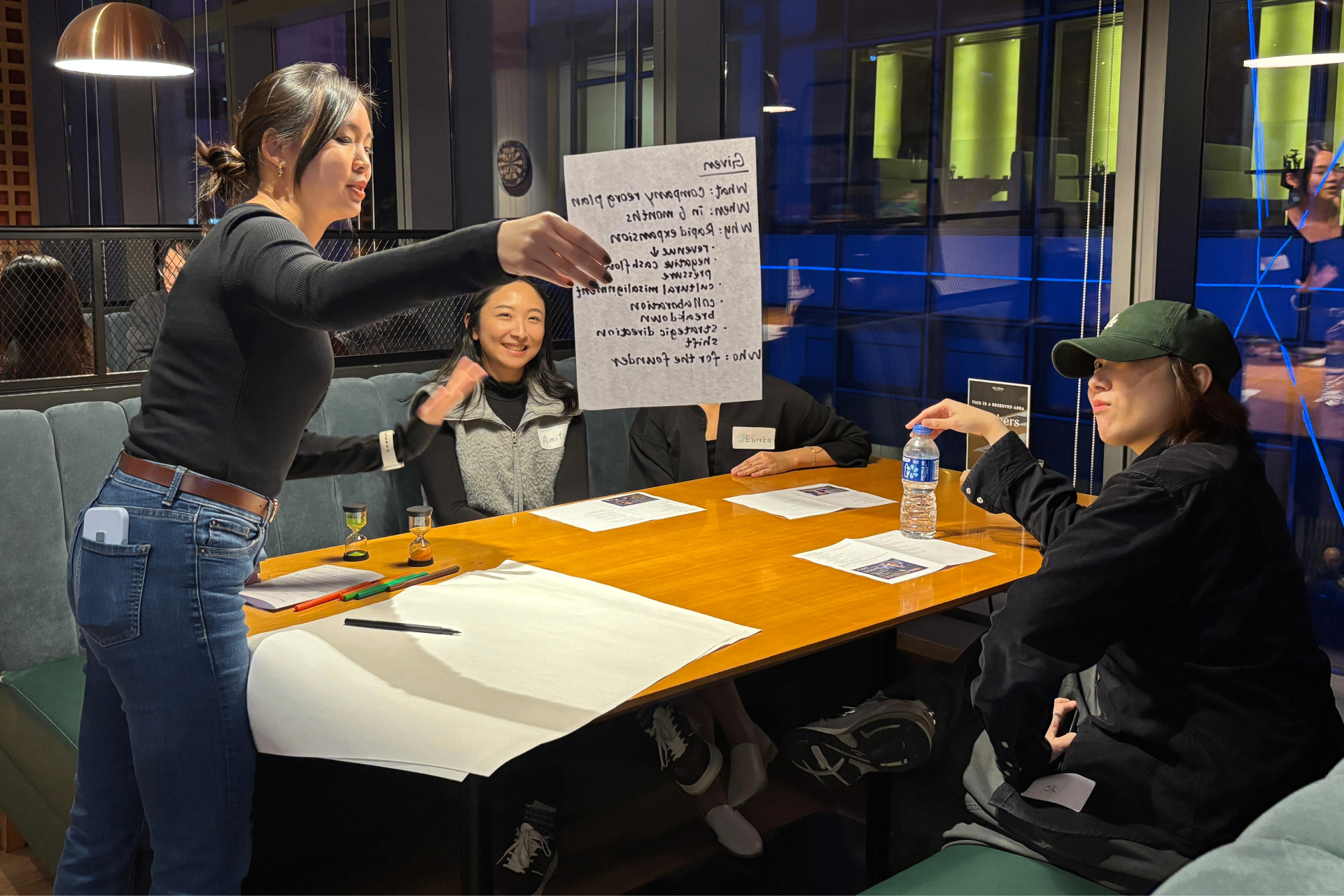 Sharon facilitating a workshop with participants around a table